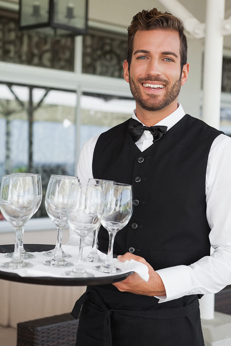 Smiling waiter with tray