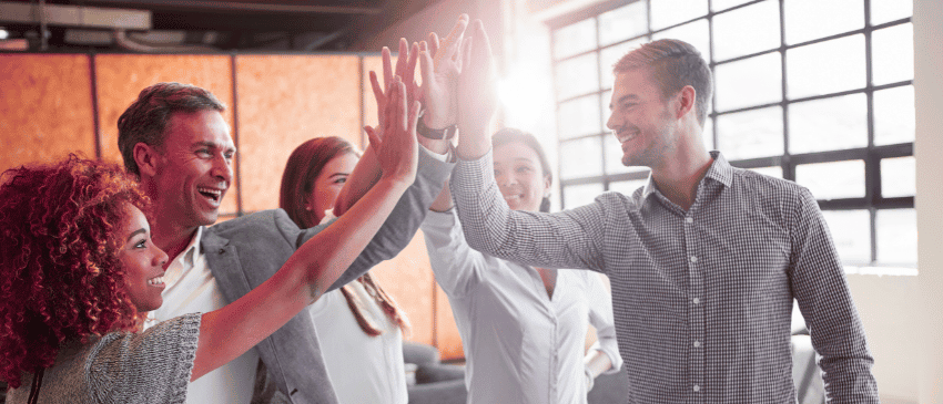 Team high fiving as recognition of a good job.