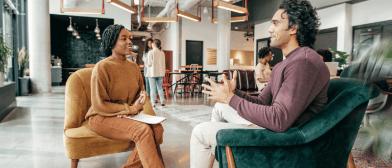 A man and a women discuss the return on investment (ROI) on coaching