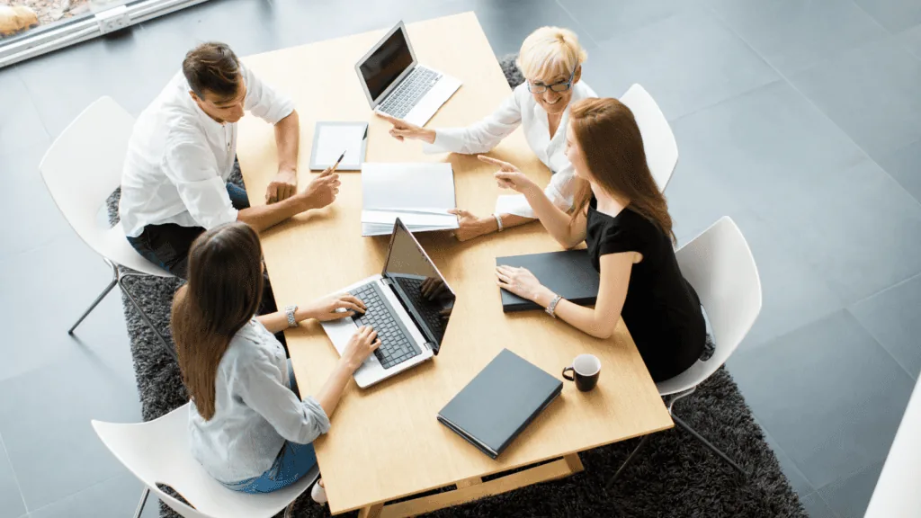 Using the Five Behavoirs Program, a team is in a workshop designed to build trust and teamwork.