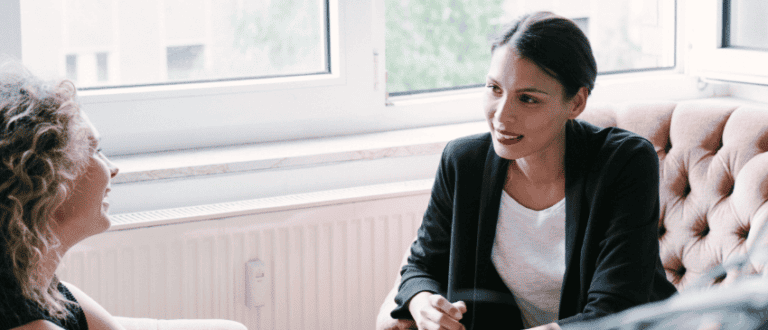 Office scene with two women taking part in an executive coaching session.